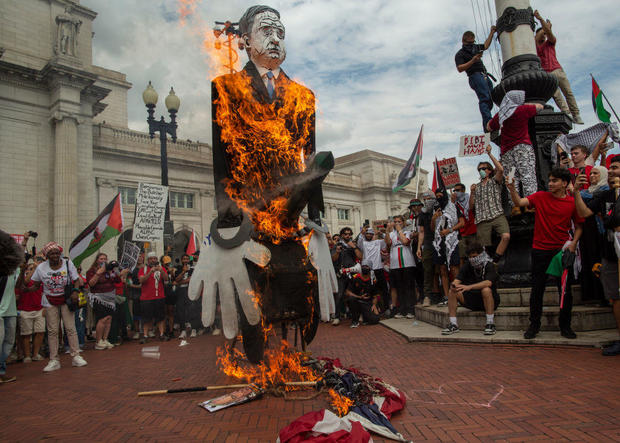 Pro-Palestinian demonstrators burn a U.S. flag and a puppet of Israeli Prime Minister Benjamin Netanyahu at Union Station in Washington, D.C., on Wednesday, July 24, 2024. 