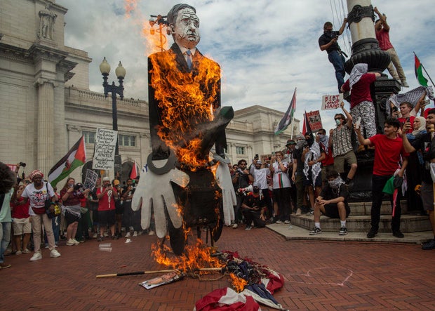 Pro-Palestinian demonstrators burn a U.S. flag and a puppet of Israeli Prime Minister Benjamin Netanyahu at Union Station in Washington, D.C., on Wednesday, July 24, 2024.