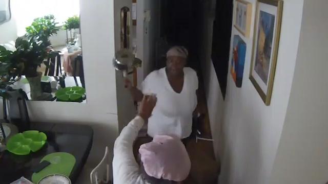 A home health care aide brandishes a small pot at a 95-year-old woman inside her Harlem home. 
