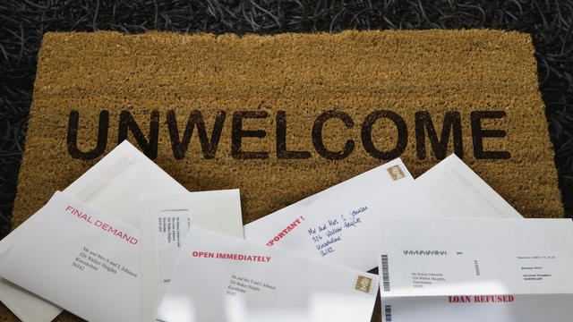 Doormat covered in unwelcome bills 