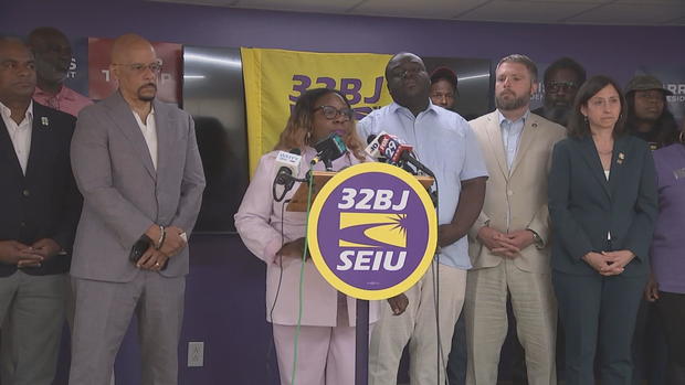 Philadelphia leaders stand around a podium during an event 