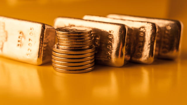 Gold bars and stack of gold coins. Background for finance banking concept. Trade in precious metals. 