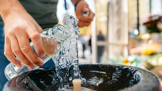 Mid-Adult Man Refiling His Reusable Water Bottle On The Drinking Fountain In Yerevan In Armenia 