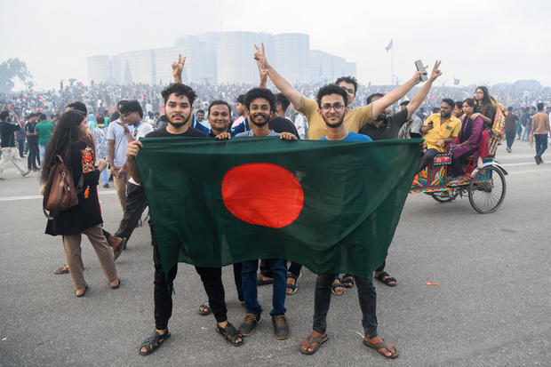 Anti-government protesters hold the Bangladeshi flag at the 