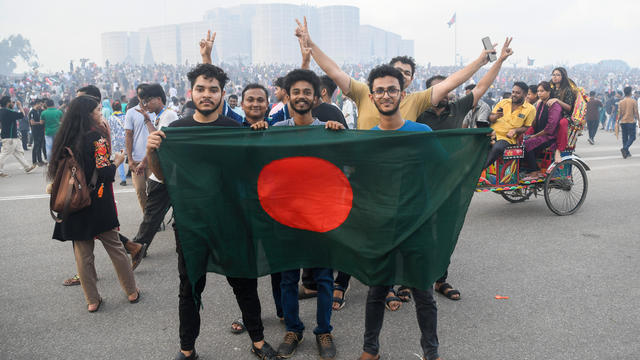 Anti-government protesters hold the Bangladeshi flag at the 
