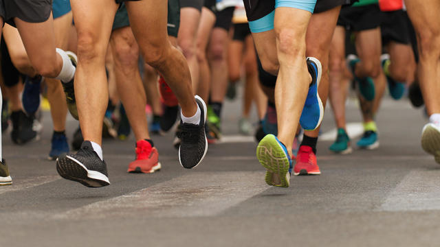 Marathon runners running on city road 