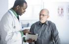 African American doctor talking to patient in office 