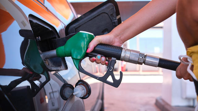 Oil crisis raises price of diesel and gasoil - a woman filling the gas tank 