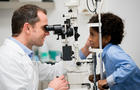 Boy getting an eye exam at the optician 