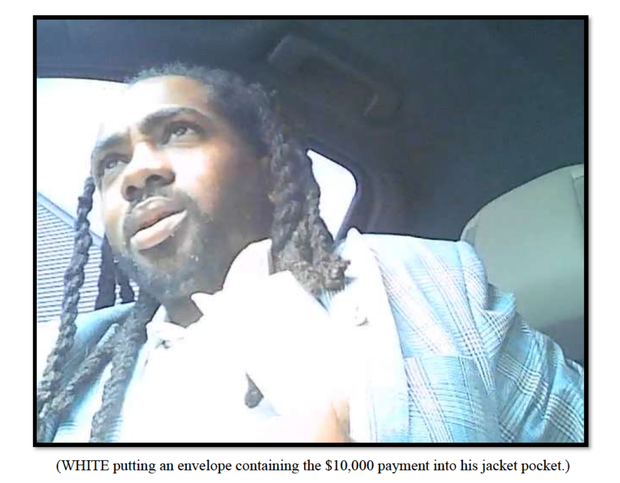 A screenshot of a video shot by a confidential informant allegedly showing D.C. Councilmember Trayon White accepting an envelope with $10,000 in cash. The image was included in an affidavit charging White with bribery on Monday, Aug. 19, 2024.