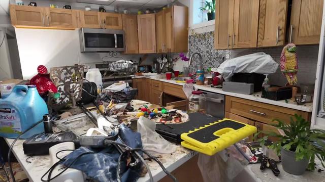 Debris and dirty belongings cover a kitchen inside a Long Island basement home damaged by floodwaters. 