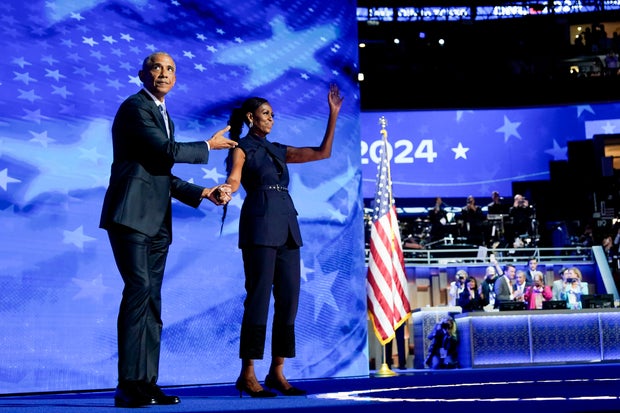 Former President Barack Obama arrives to speak next to former first lady Michelle Obama during the Democratic National Convention on Tuesday, Aug. 21, 2024.