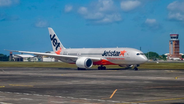 Passenger opens jet's door and walks on wing after landing at Australia airport