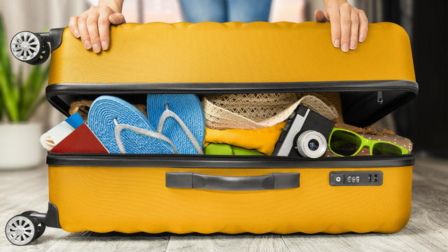 woman packing suitcase 