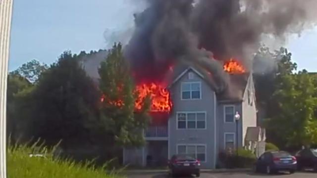 Video from a Ring camera shows an apartment building on fire. 