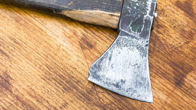 Close-up of an axe lying on the tool bench. 