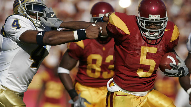 USC's Reggie Bush grabs the facemask of UCLA Bruin Jarrad Page in USC's 66–19 win at the LA Coliseu 