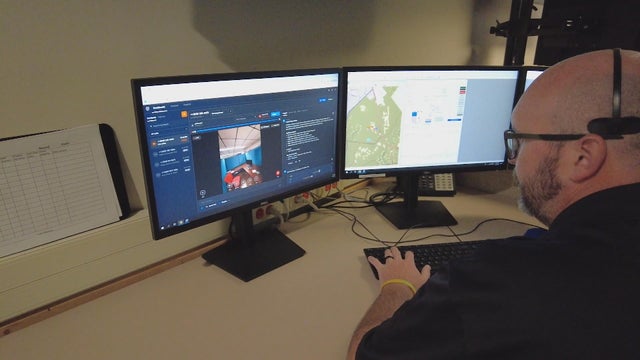 A worker at the 911 center in Delaware County views a video call on his computer 