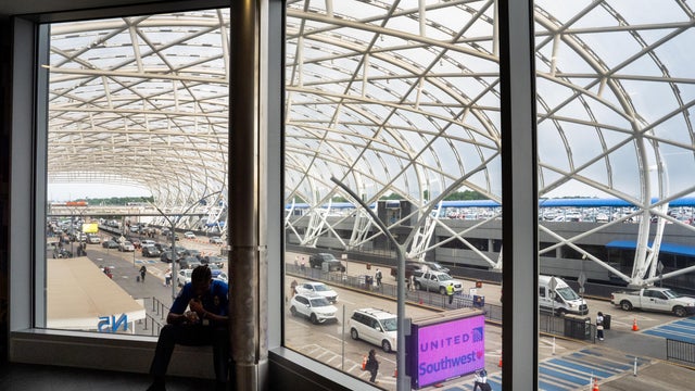 A Transportation Security Administration worker sits on break at Hartsfield-Jackson Atlanta International Airport on June 28, 2024, in Atlanta, Georgia. 