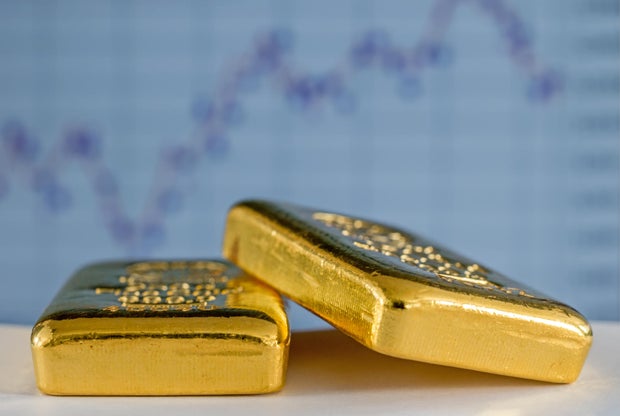Gold bars on the background of the growth chart.