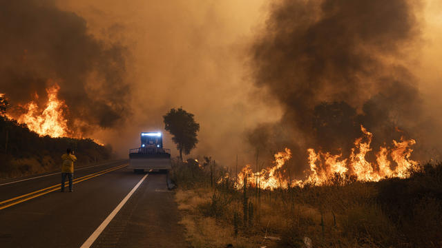 A Cal Fire bulldozer retreats as there Airport Fire 