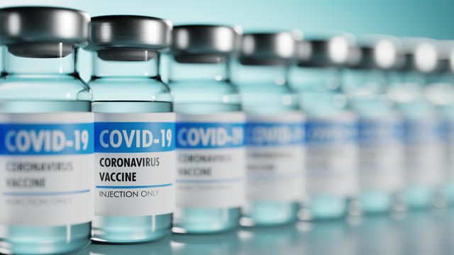 Row of Coronavirus vaccine flasks. Shallow depth of field. 