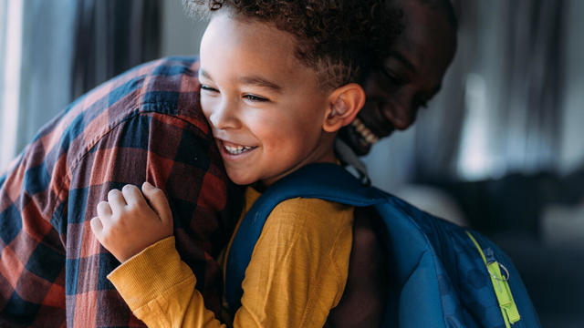 Cute boy with his father on the first day of school. 