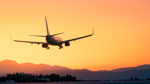 Epic landing with the sunset and the mountains, plane landing beneath a breathtaking sunset, sunset landing 