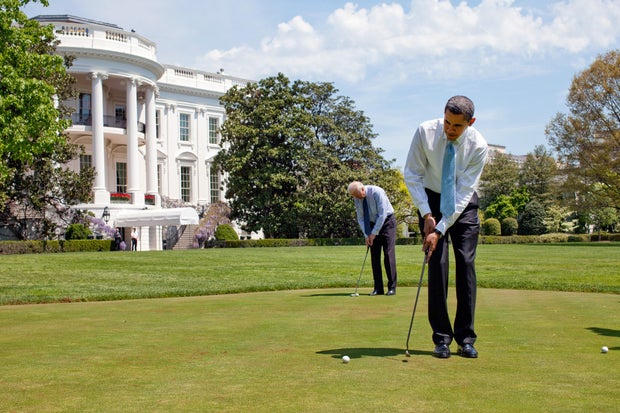 Reportage: President Barack Obama and Vice President Joe Biden practice their putting on the White House putting green April 24 2009.