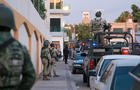 Cartel gunmen are seen outside during clashes with federal forces following the detention of Ovidio Guzman, son of drug kingpin Joaquin "El Chapo" Guzman, in Culiacan 