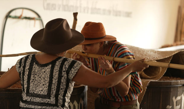 Cecilia Vega learns about the mezcal making process from Graciela Ángeles Carreño.