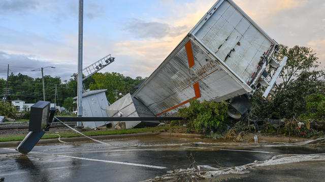 A damaged car sits under a destroyed shed after flooding caused by Hurricane Helene in Swannanoa, North Carolina, on Oct. 3, 2024. 