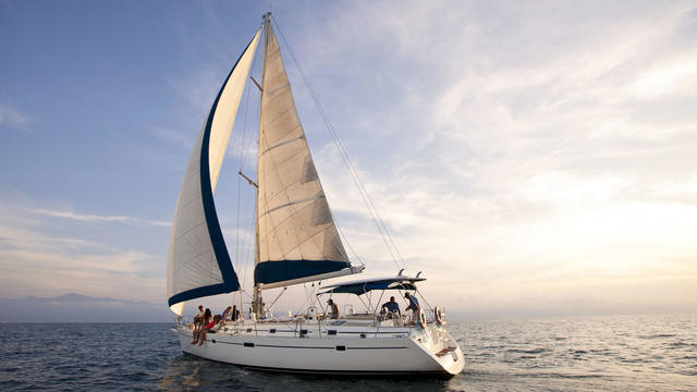 Sunset on the open ocean w/beautiful sailboat 