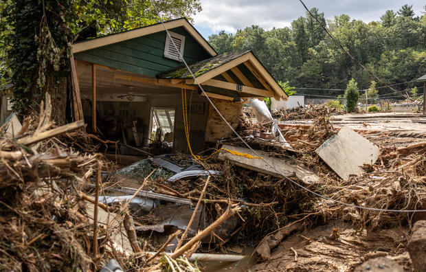 A destroyed house with a car under it is seen in Chimney Rock, North Carolina, Sept. 29, 2024. 