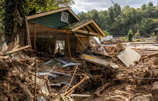 A destroyed house with a car under it is seen in Chimney Rock, North Carolina, Sept. 29, 2024.