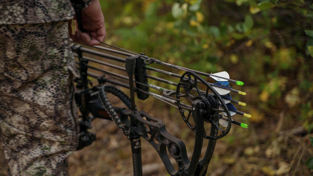 Cropped photo of a hunter carrying a crossbow 