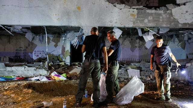 Israeli rescue force secures the site where a missile fired from Iran towards Israel hit a school building in central Israel 