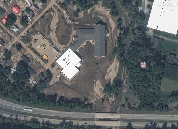 A satellite view shows mud and debris near Old Fort Elementary School, North Carolina