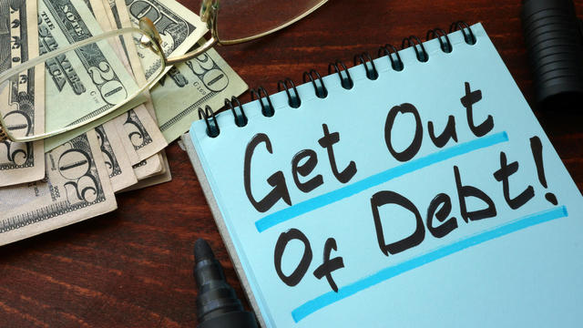 Get out of Debt written on a notepad with marker. 