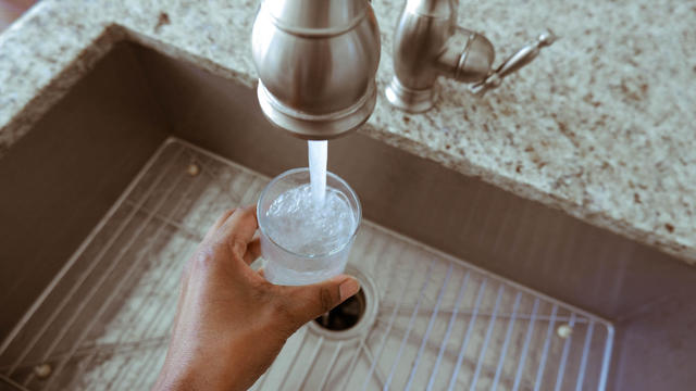 Woman Fills Glass of Water 