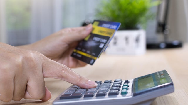 woman calculate how much cost or spending have with credit cards 