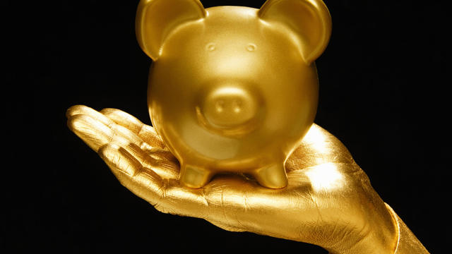 Golden hand and piggie bank 