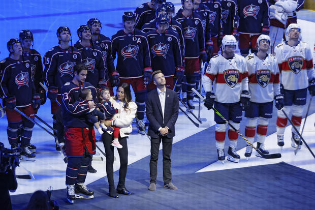 Blue Jackets' Johnny Gaudreau's family watches a #13 banner being raised during a ceremony before the start of an NHL hockey game between the Columbus Blue Jackets and the Florida Panthers 