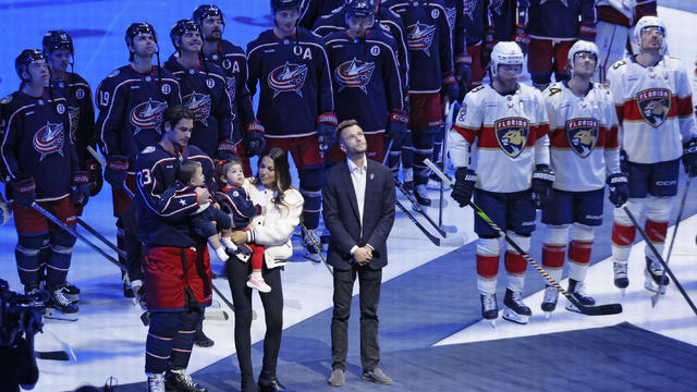 Blue Jackets' Johnny Gaudreau's family watches a #13 banner being raised during a ceremony before the start of an NHL hockey game between the Columbus Blue Jackets and the Florida Panthers 