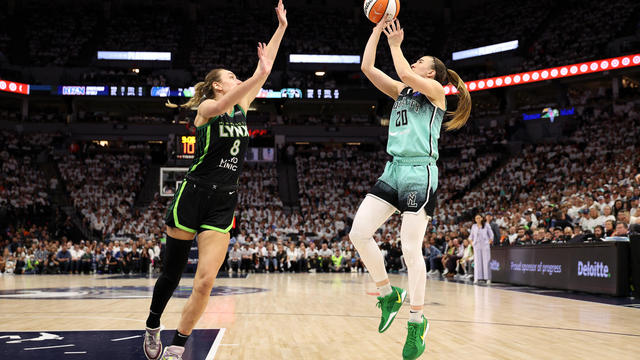 Sabrina Ionescu #20 of the New York Liberty shoots the ball against Alanna Smith #8 of the Minnesota Lynx during the fourth quarter in Game Three of the WNBA Finals at Target Center on October 16, 2024 in Minneapolis, Minnesota. 