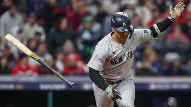 Gleyber Torres #25 of the New York Yankees tosses his bat after hitting an RBI single in the ninth inning during Game 4 of the ALCS presented by loanDepot between the New York Yankees and the Cleveland Guardians at Progressive Field on Friday, October 18, 2024 in Cleveland, Ohio. 