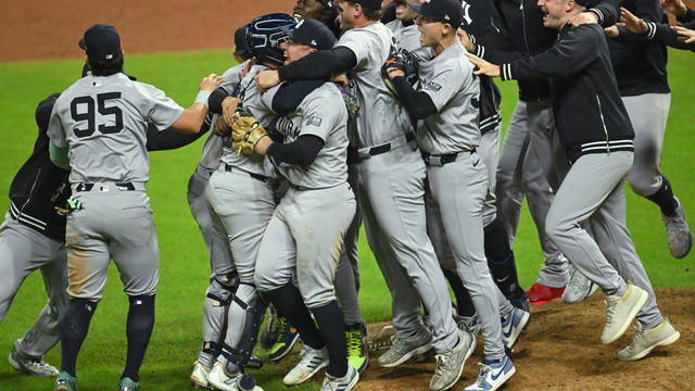 The New York Yankees celebrate after beating the Cleveland Guardians 5-2 in 10 innings to win Game Five of the American League Championship Series at Progressive Field on October 19, 2024 in Cleveland, Ohio. 