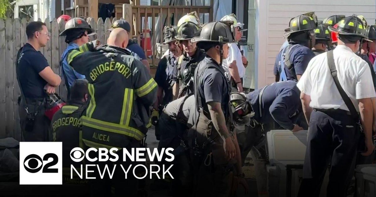 Construction worker "buried up to his knee" in collapse - CBS New York