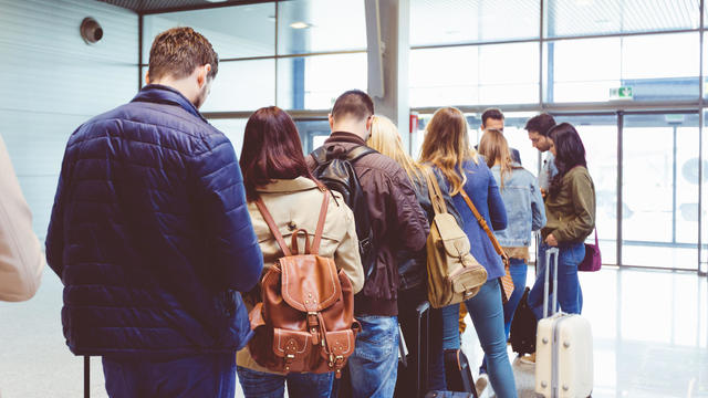 People standing in queue to board plane 