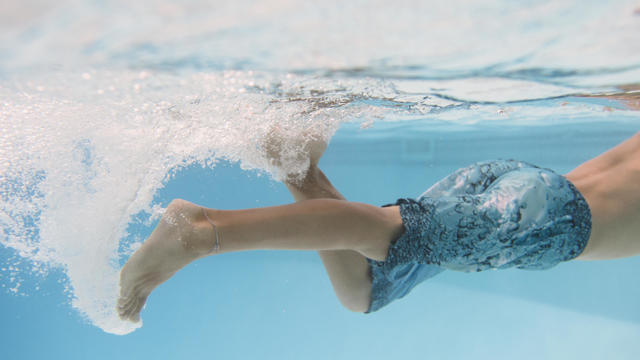 Young boy kicking underwater 